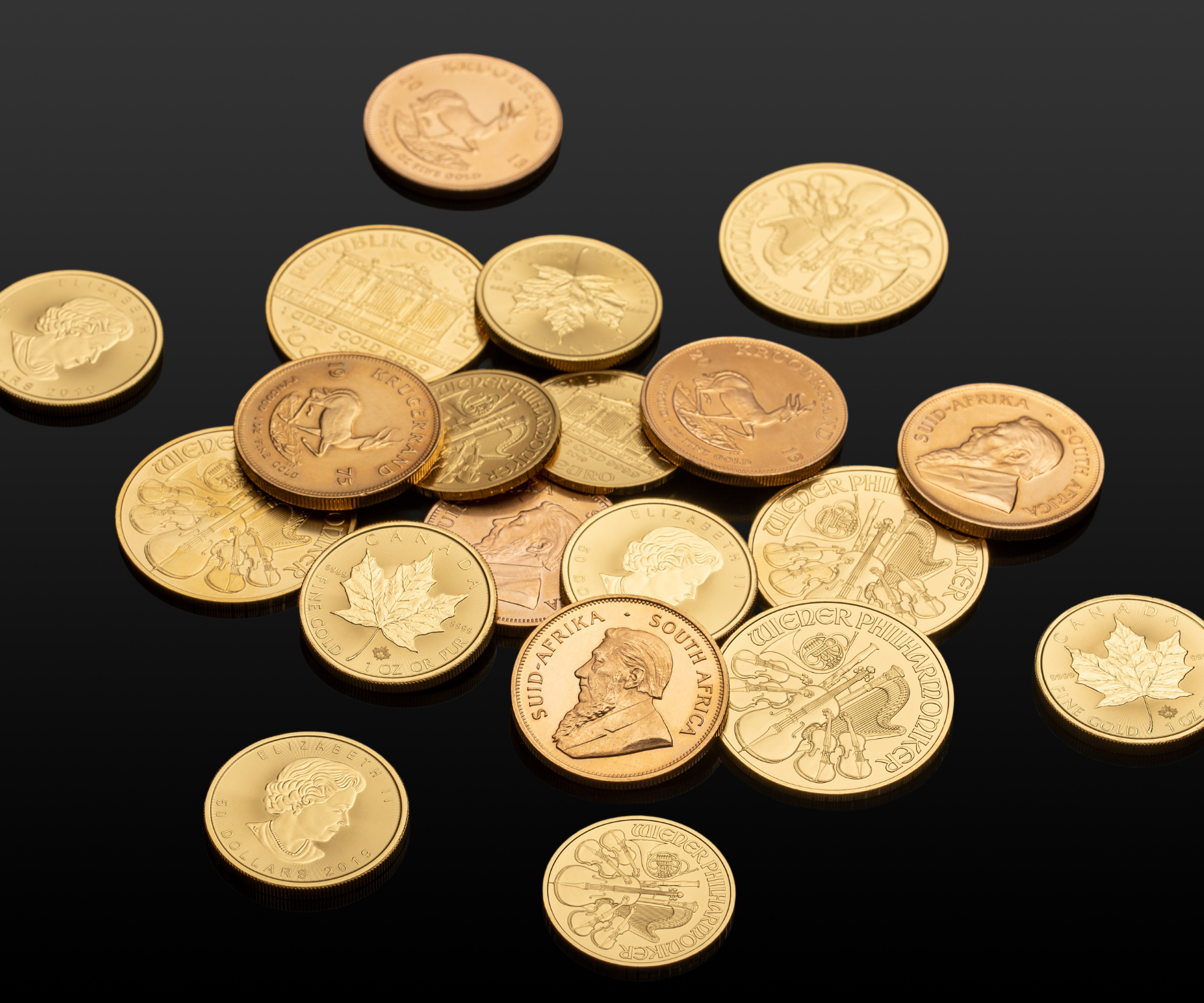 Gold bullion coins on a dark surface